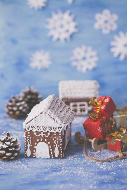 Gingerbread house on blue surface — Stock Photo