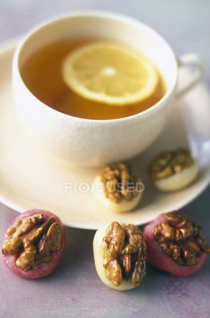 Cup of tea with marzipan — Stock Photo