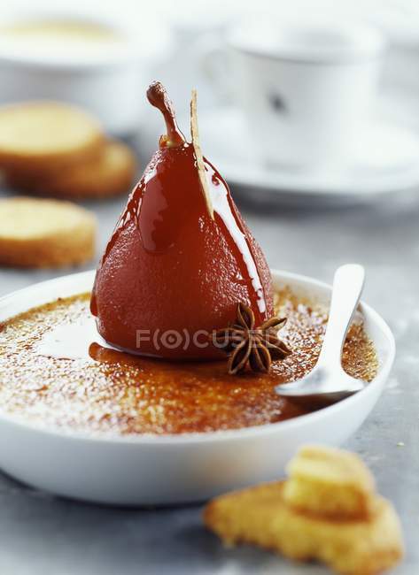 Closeup view of spiced pear on Creme Brulee — Stock Photo