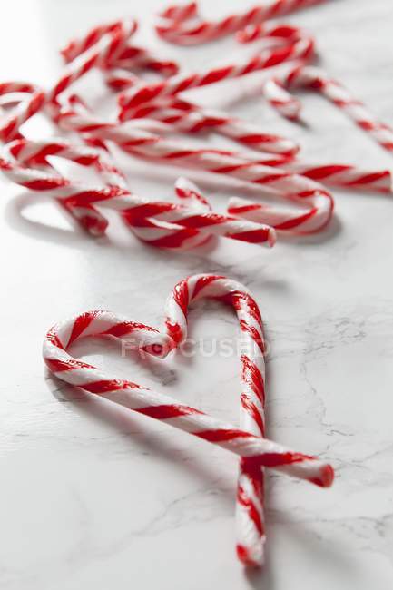 Candy canes forming a heart shape — Stock Photo