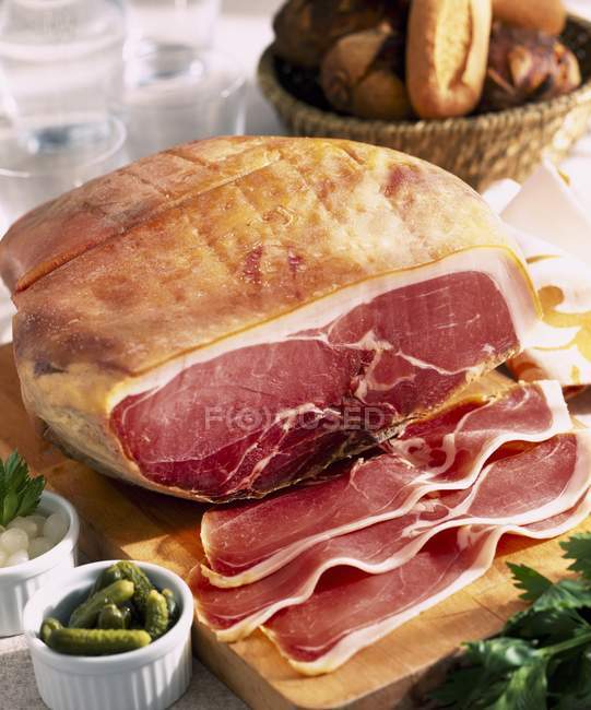 Raw ham with slices — Stock Photo