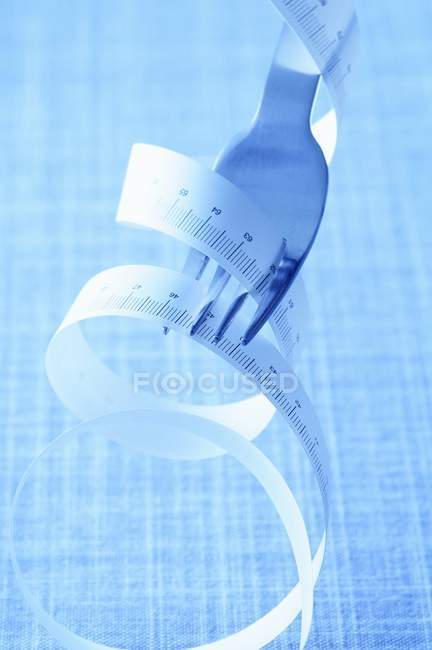 Closeup view of measuring tape wrapped around a fork — Stock Photo