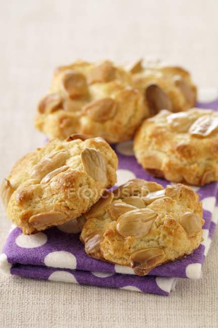 Almond cookies on purple towel — Stock Photo