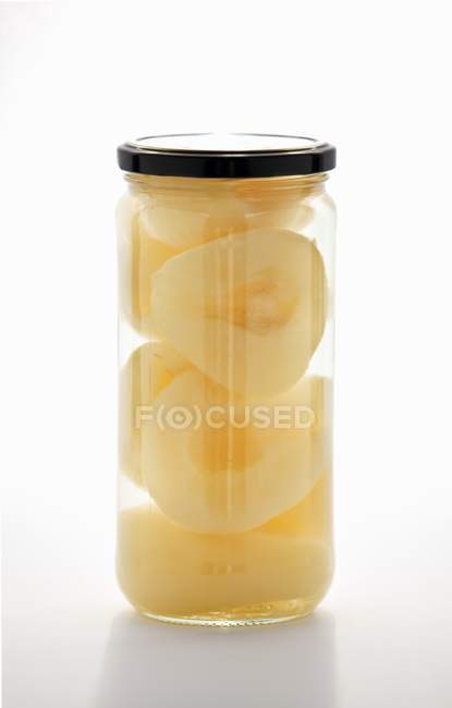 Closeup view of preserved pear halves in a jar — Stock Photo