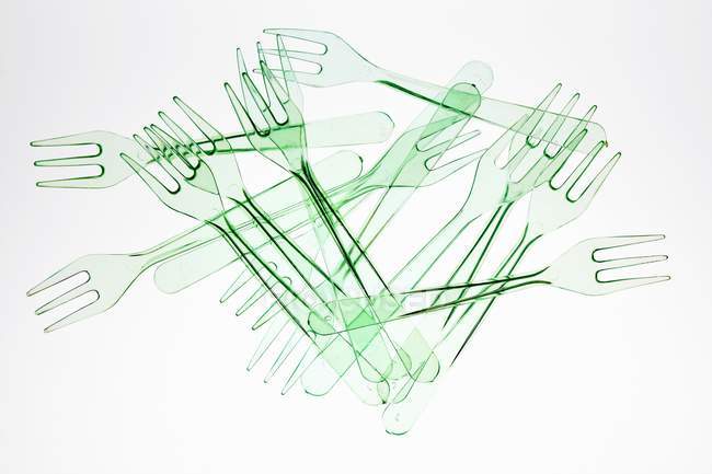 Closeup top view of plastic forks in heap on white background — Stock Photo