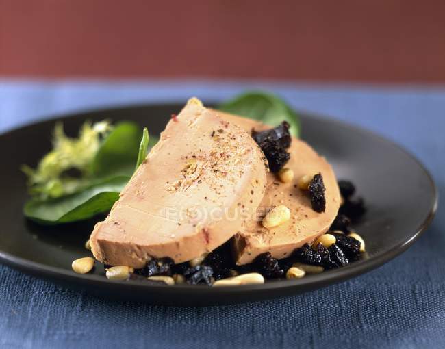 Foie gras on black plate — Stock Photo