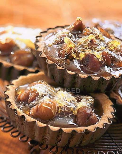 Closeup view of chestnut tarts in baking tins — Stock Photo