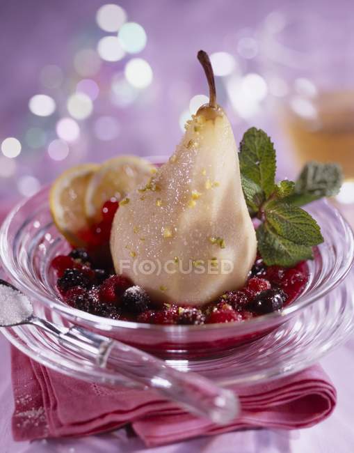 Closeup view of peeled pear and fruit sauce — Stock Photo