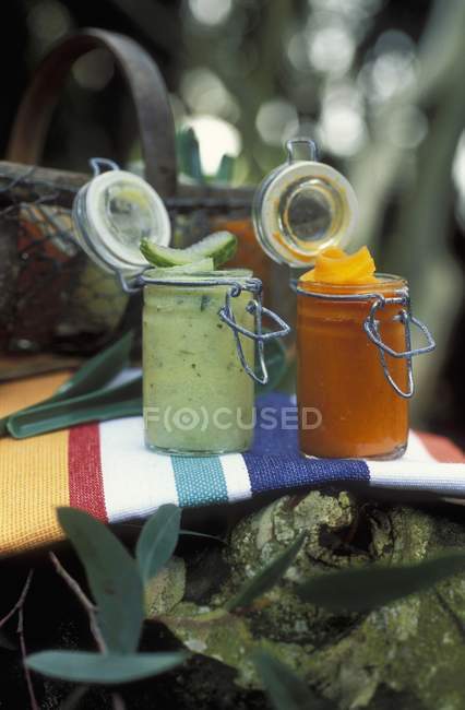 Cold cucumber and carrot soup in jars — Stock Photo