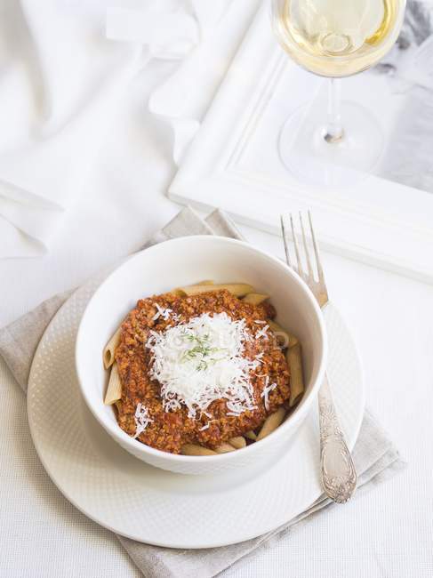 Bolognese sauce with wholegrain penne pasta — Stock Photo