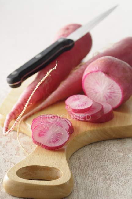 Slicing big radishes — Stock Photo