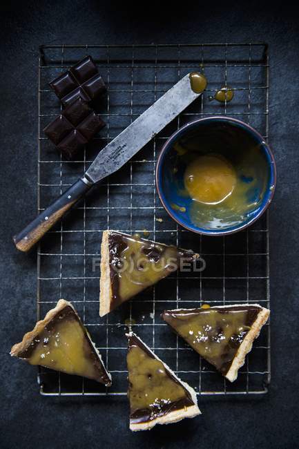 Top view of four slices of chocolate and salted caramel tart — Stock Photo