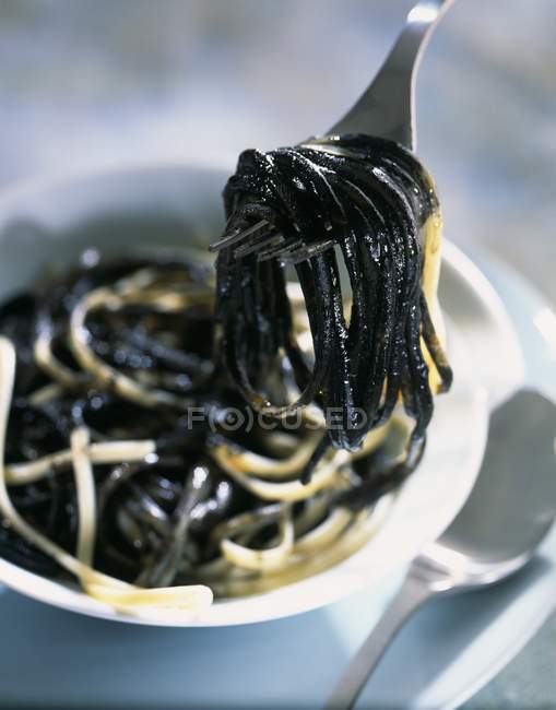 Linguine pasta with squid ink sauce — Stock Photo