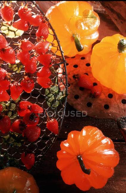 Fruits confits over wooden surface and lights — Stock Photo