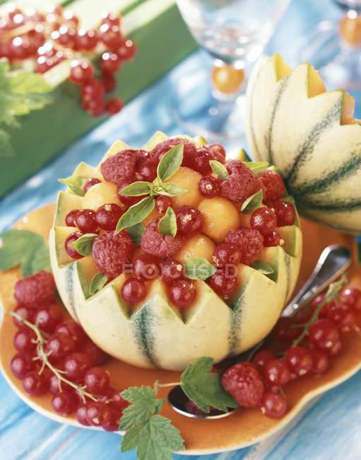 Closeup view of melon filled with fruits — Stock Photo
