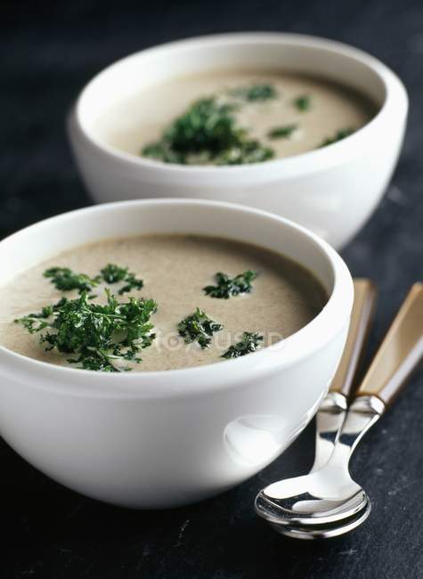 Mushroom and parsley soup in white bowls — Stock Photo
