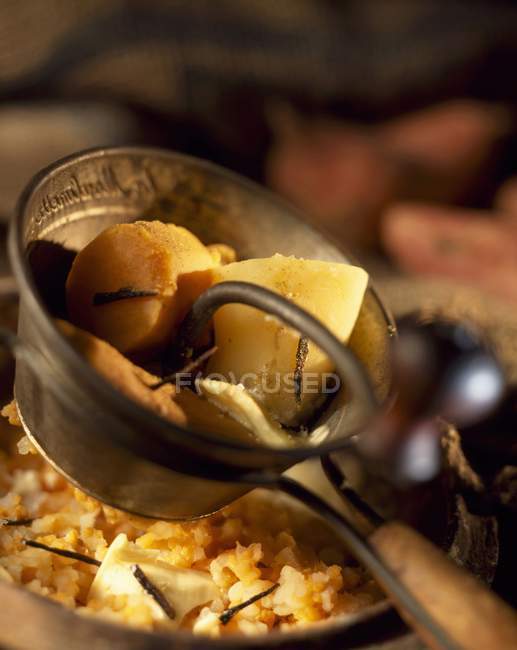 Mashing sweet potatoes in small saucepan — Stock Photo