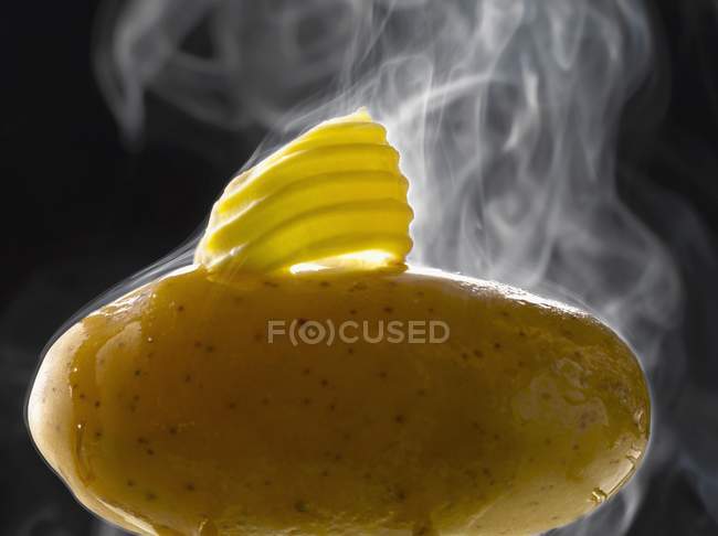 Knob of butter on potato — Stock Photo