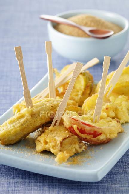 Apple and banana tempuras over platter — Stock Photo