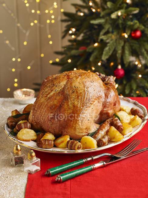 Closeup view of turkey with potatoes and ham on Christmas table — Stock Photo