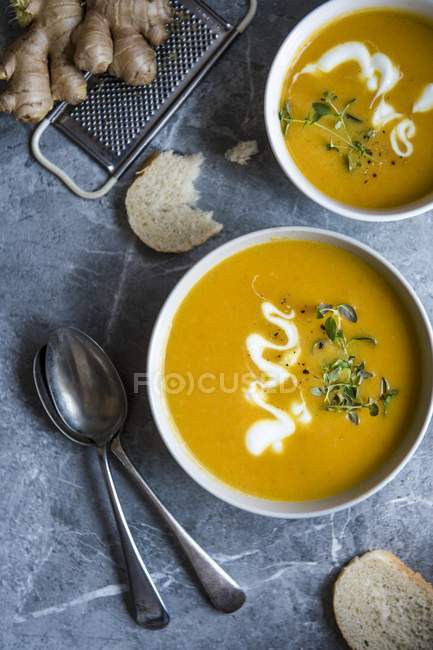 Bowls of carrot and ginger soup — Stock Photo