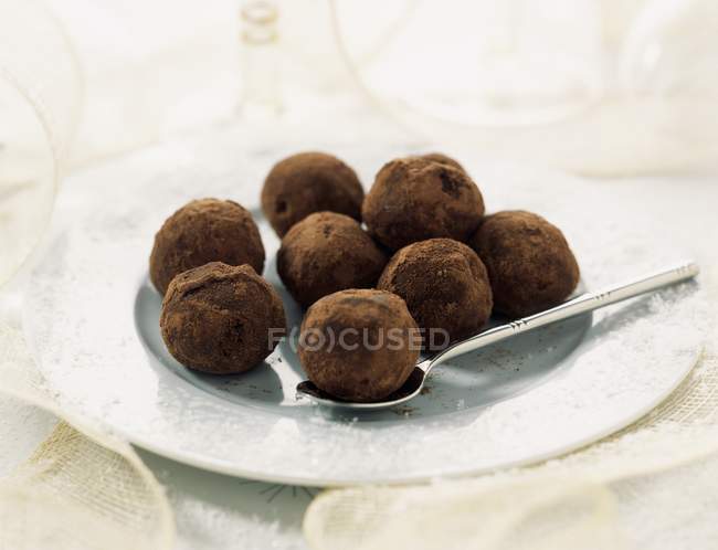 Chocolate truffles on plate — Stock Photo