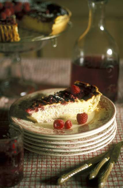Alsatian raspberry cake on stack of plates — Stock Photo