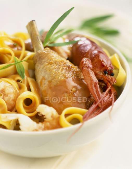 Poultry with crawfish and tagliatelle pasta — Stock Photo