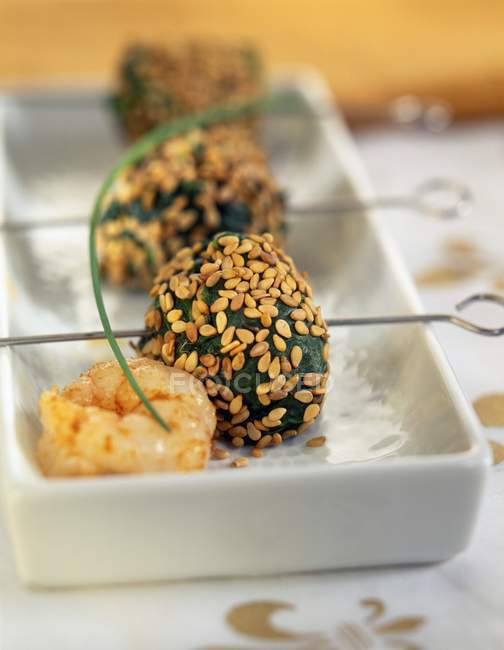 Spinatbällchen mit Sesam auf weißem Teller — Stockfoto