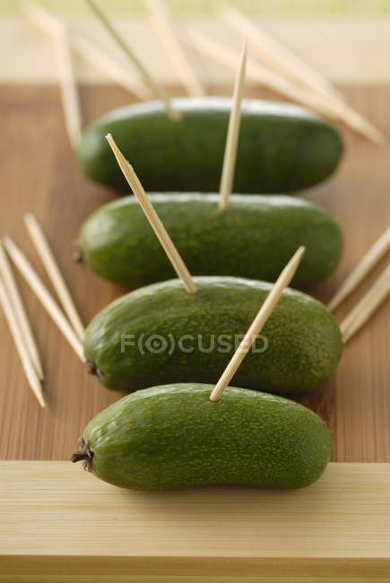 Cocktail avocados with wooden sticks — Stock Photo