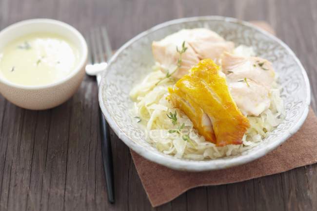 Fish Sauerkraut with thyme  on white plate over napkin on wooden surface — Stock Photo