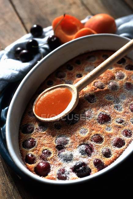 Closeup view of cherry Clafoutis with apricot Coulis — Stock Photo