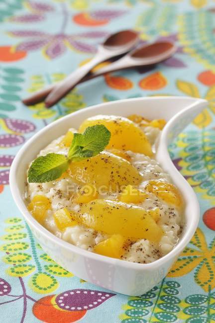 Rice pudding with peaches — Stock Photo