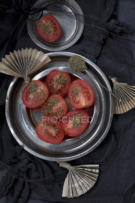 Tomatoes with dried oregano — Stock Photo