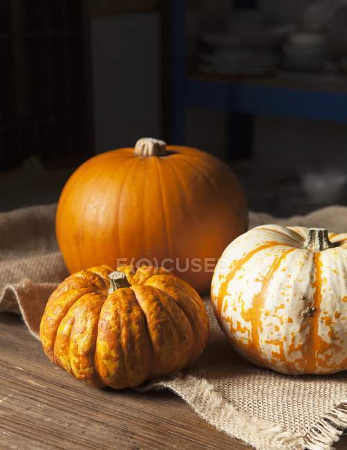 Various pumpkins on cloth — Stock Photo