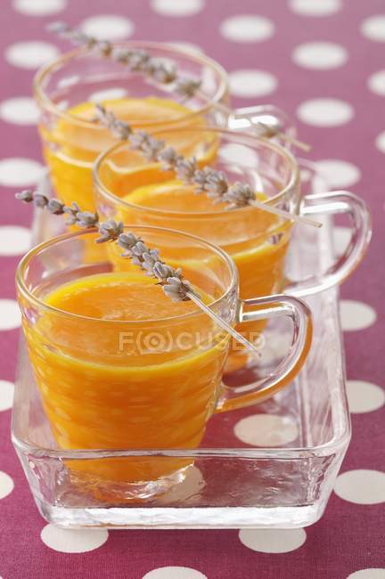 Melon soup with lavander in cups over tray — Stock Photo