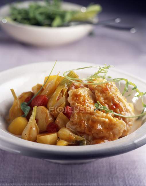Fish with tomatoes and onions — Stock Photo
