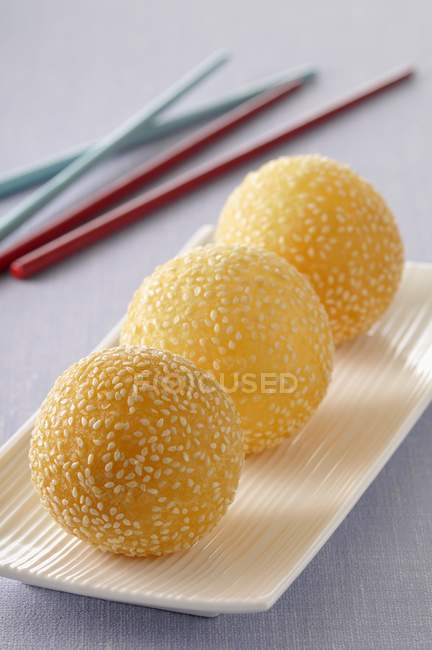 Golden sesame balls on white plate — Stock Photo