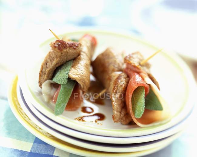 Saltimbocca on stacked plates — Stock Photo