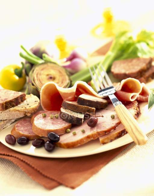 Plate of cured meats — Stock Photo