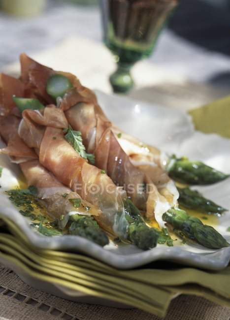 Green asparagus in ham — Stock Photo