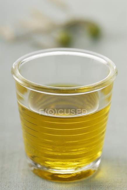 Glass of olive oil — Stock Photo