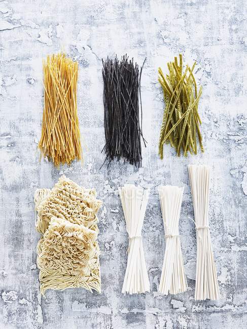 Assorted types of dry uncooked pasta — Stock Photo