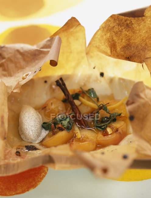 Closeup view of poached apricots with vanilla in paper — Stock Photo
