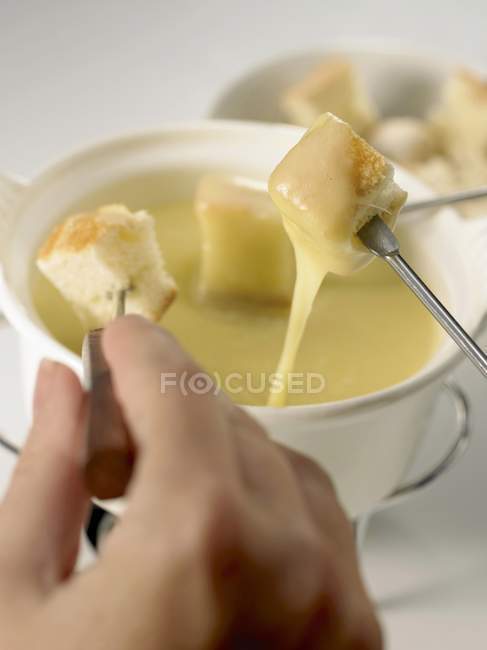 Cheese fondue with cubes — Stock Photo