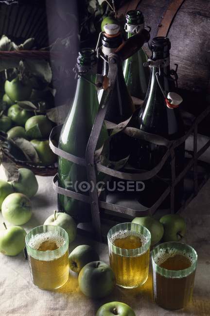 Cider and apples in glasses — Stock Photo