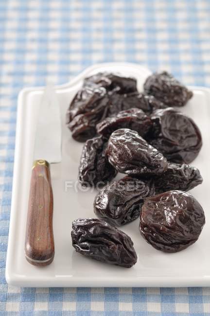 Heap of Prunes on desk — Stock Photo