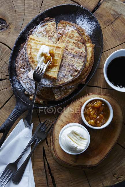 Closeup top view of waffles with cream and cloudberries — Stock Photo