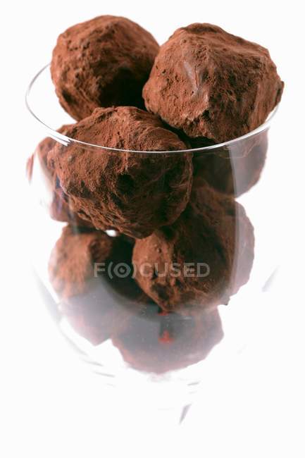 Chocolate truffles in glass — Stock Photo