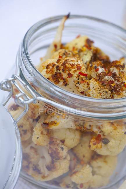 Oven-roasted cauliflower in a flip-top glass jar — Stock Photo